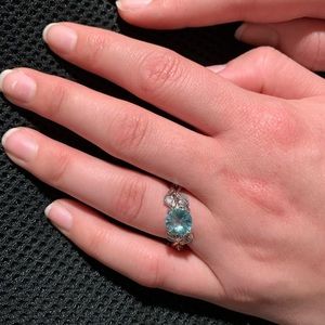 AQUAMARINE AND WHITE SAPPHIRE ON SIDE OF 925 RING